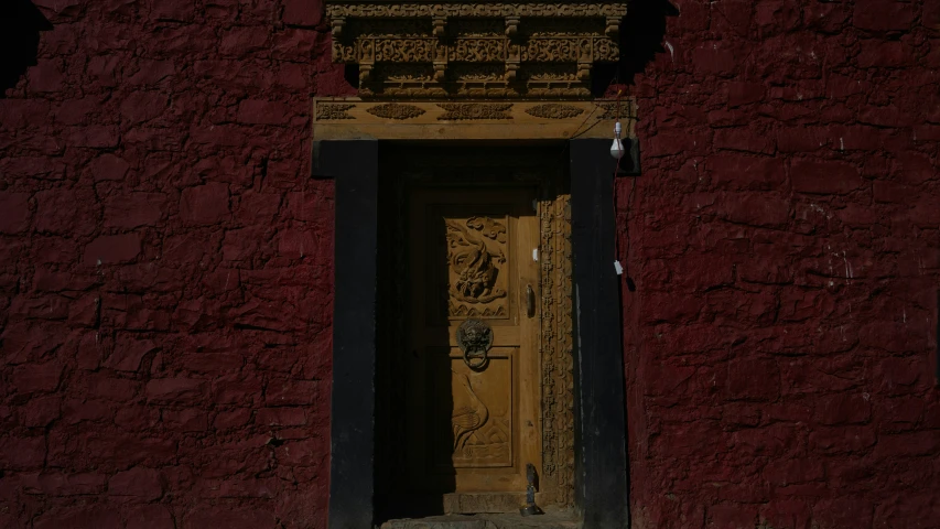 an old doorway with carving of flowers and a door frame