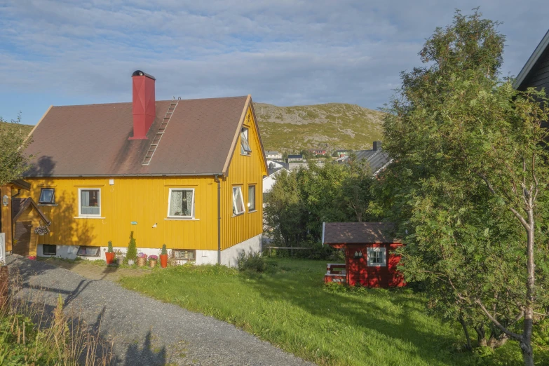 a big home with some dirt road in front of it