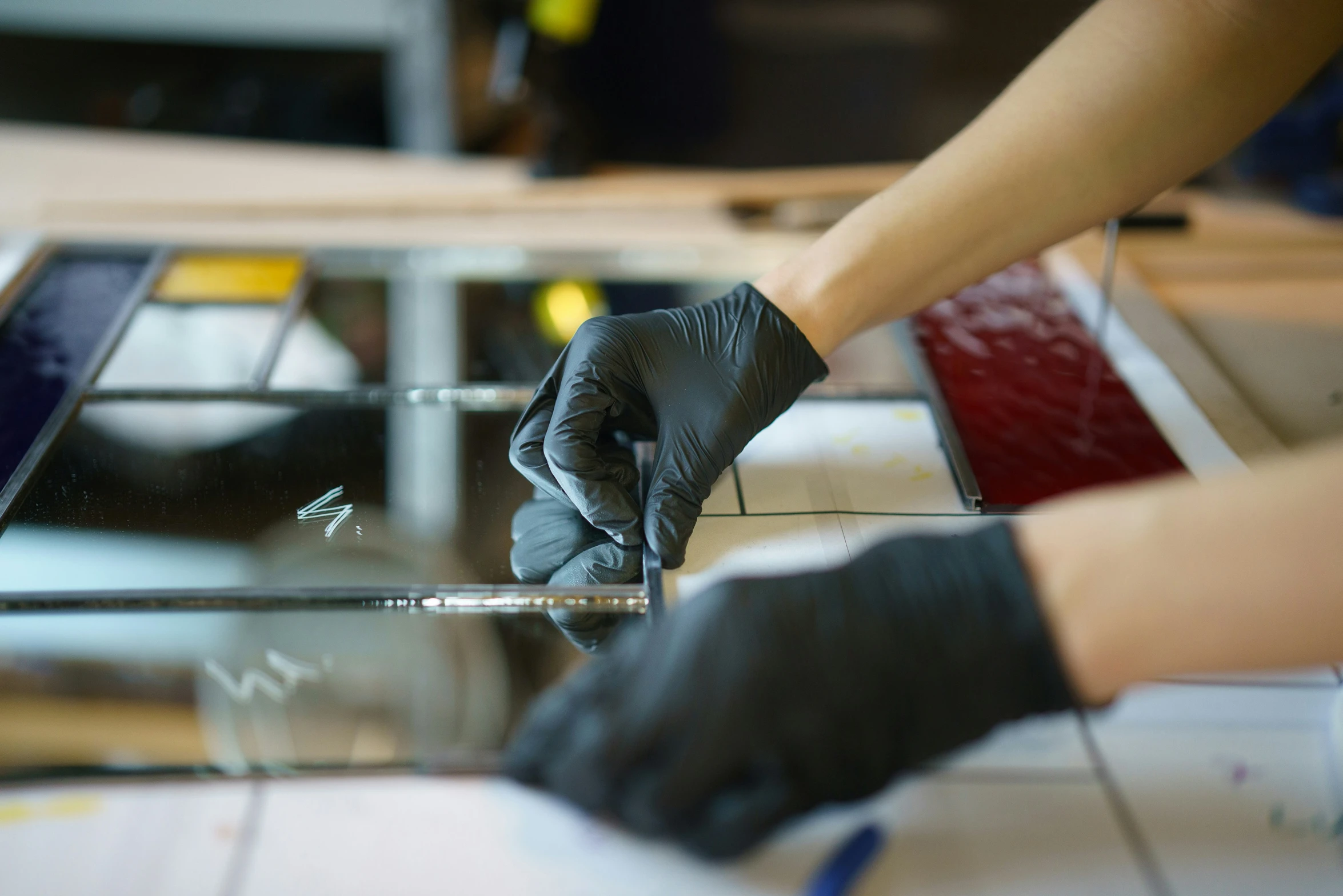 a person putting a small piece of glass into a container