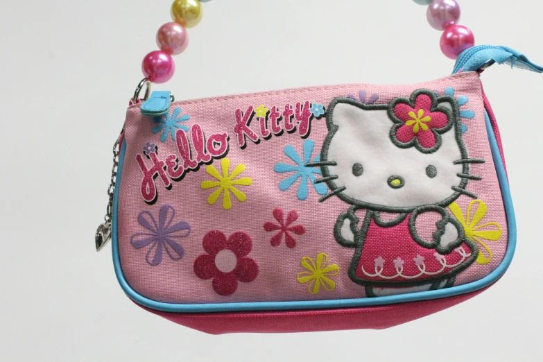 hello kitty purse hanging with beaded string around it