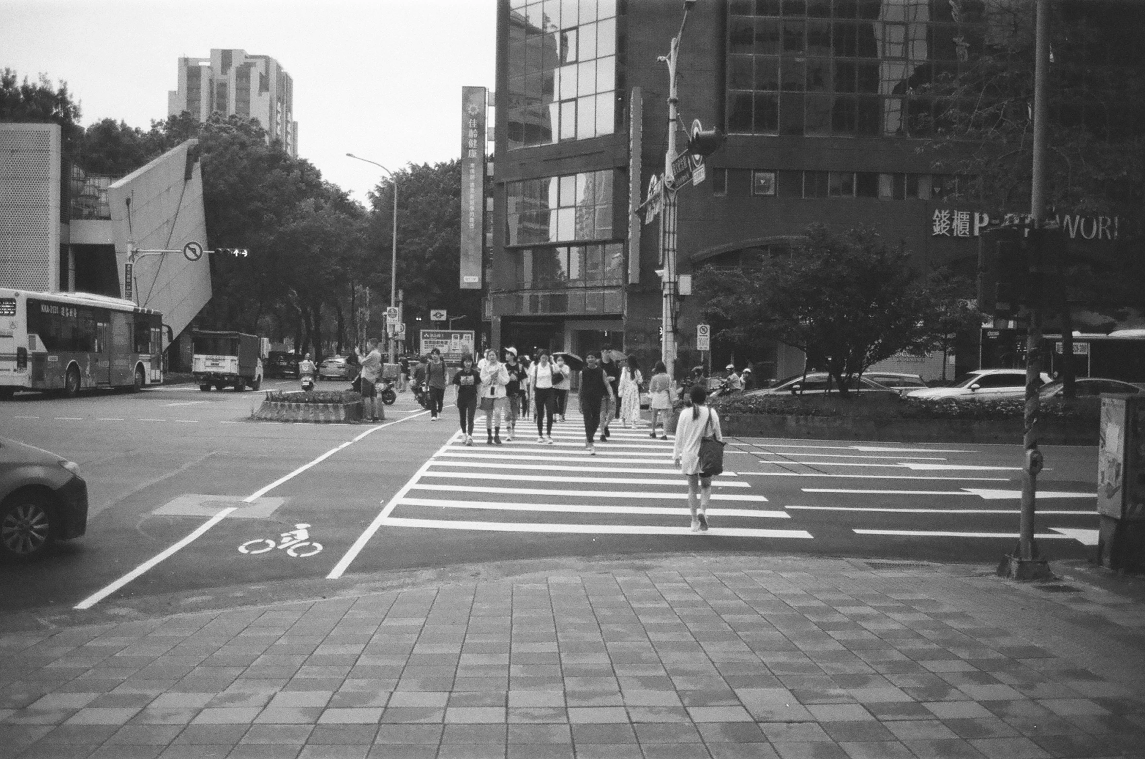 a busy city street that has people crossing