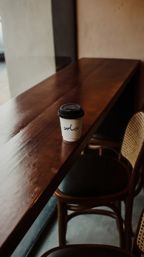 a coffee cup sitting on a table in a cafe