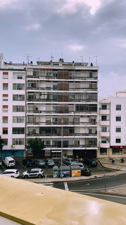 an apartment building is shown on a partly cloudy day