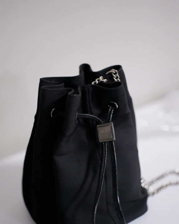 the black bag is attached to a metal chain