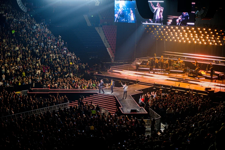 a concert is shown as a crowd looks on