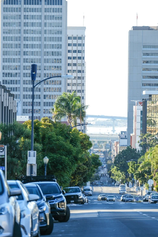 a city street filled with traffic surrounded by tall buildings