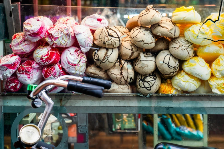 a bicycle parked in front of a fruit stand