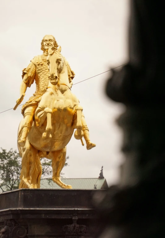 the statue has a man on horseback on top of it