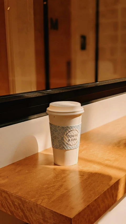 a coffee cup sitting on top of a wooden counter