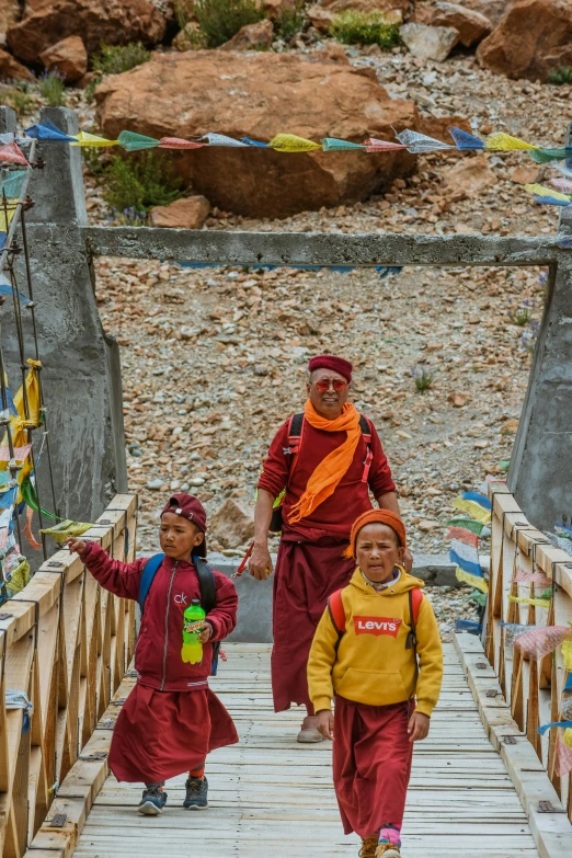 two women and a child are crossing a bridge