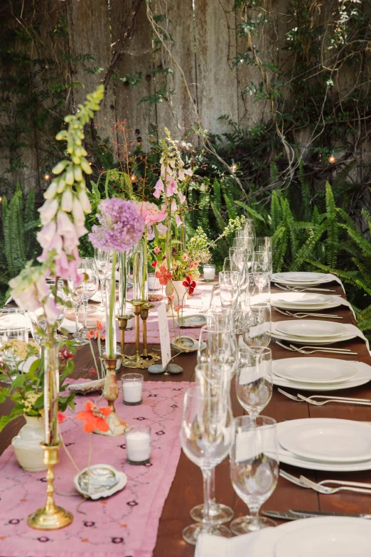 a table that has several dinner plates and place settings on it