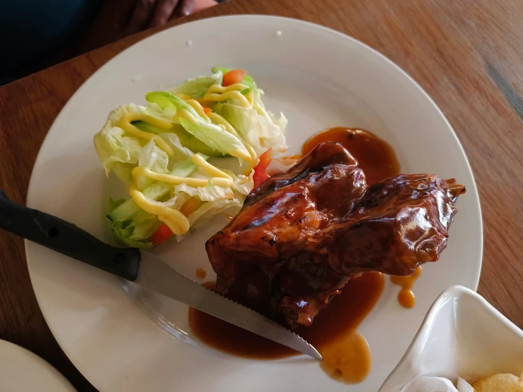 a plate with meat and vegetable on it