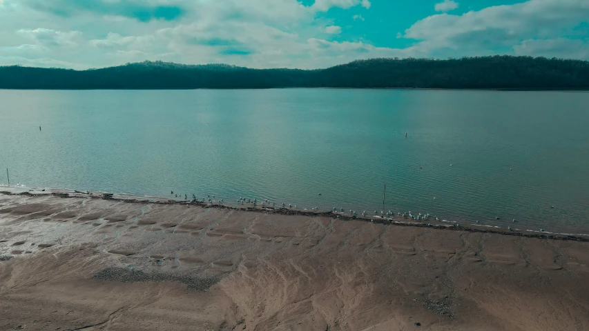 an old po of a beach in the middle of a ocean