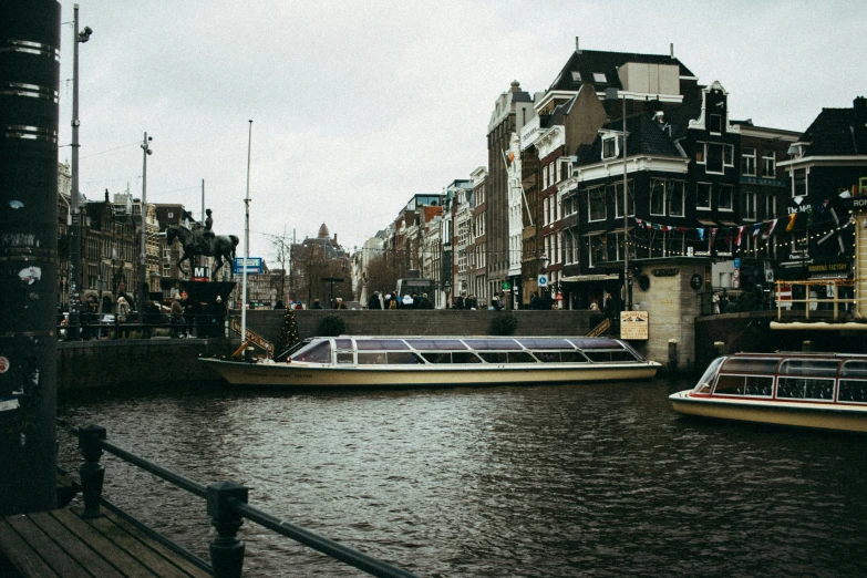 boats are in the river on a cloudy day