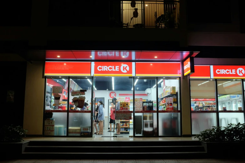 a shop front at night with people inside