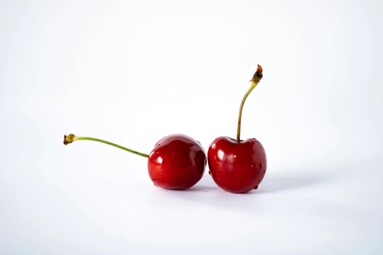 two cherries in the shape of a face