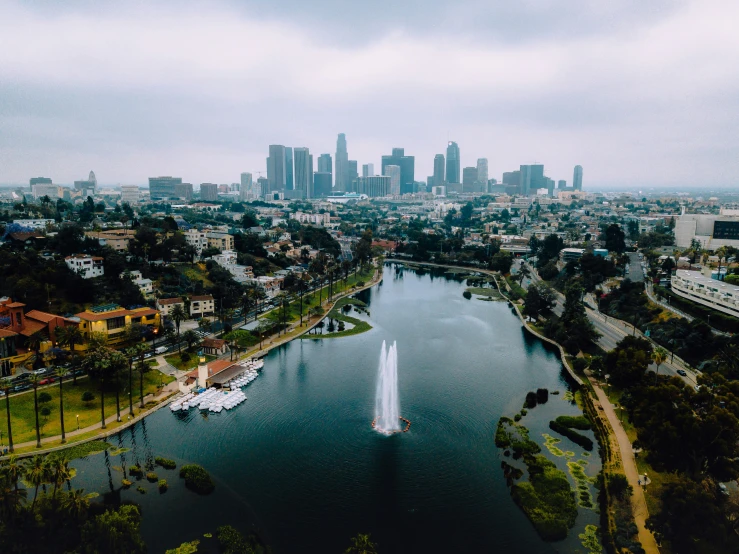 the city skyline from above the water with lots of buildings and boats on it