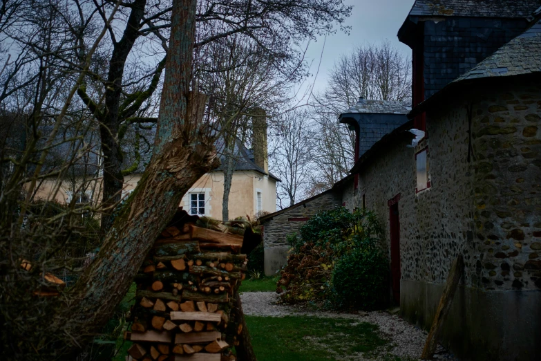 a building that has some logs in front of it