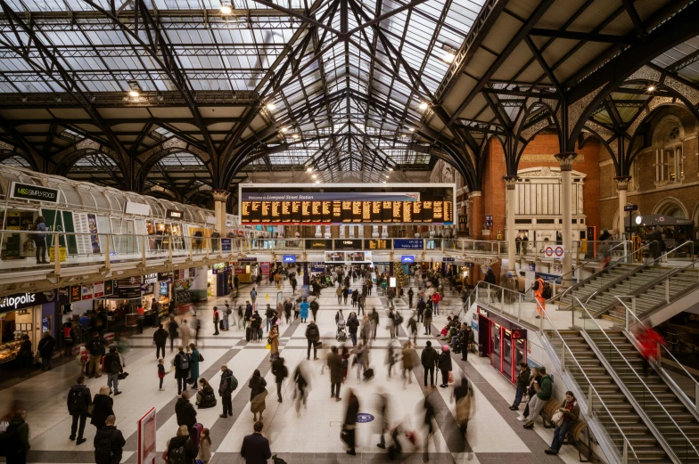 a group of people walking down a train station