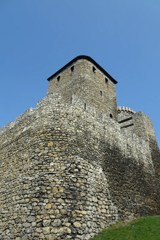 an ancient looking stone building with a clock tower