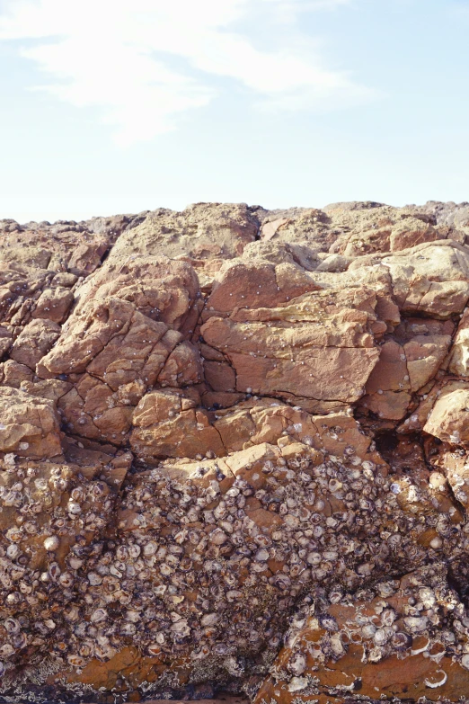 rocks and gravel with sky and clouds behind them