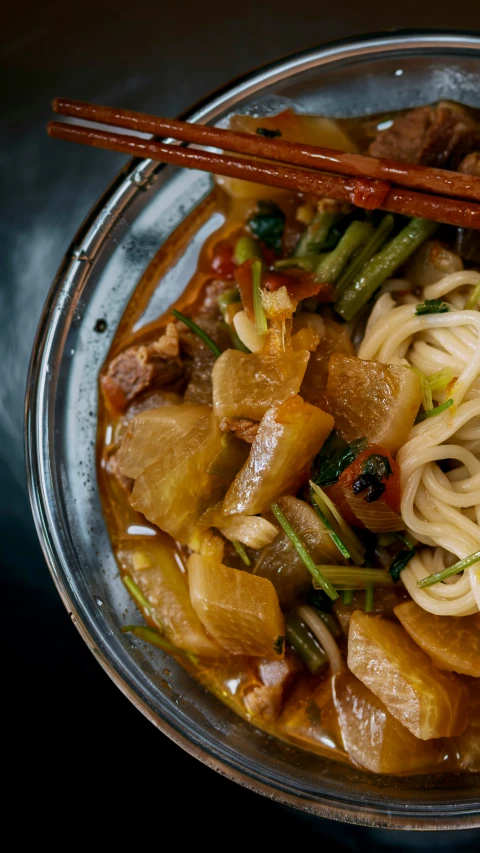 a plate that has some noodles and vegetables in it