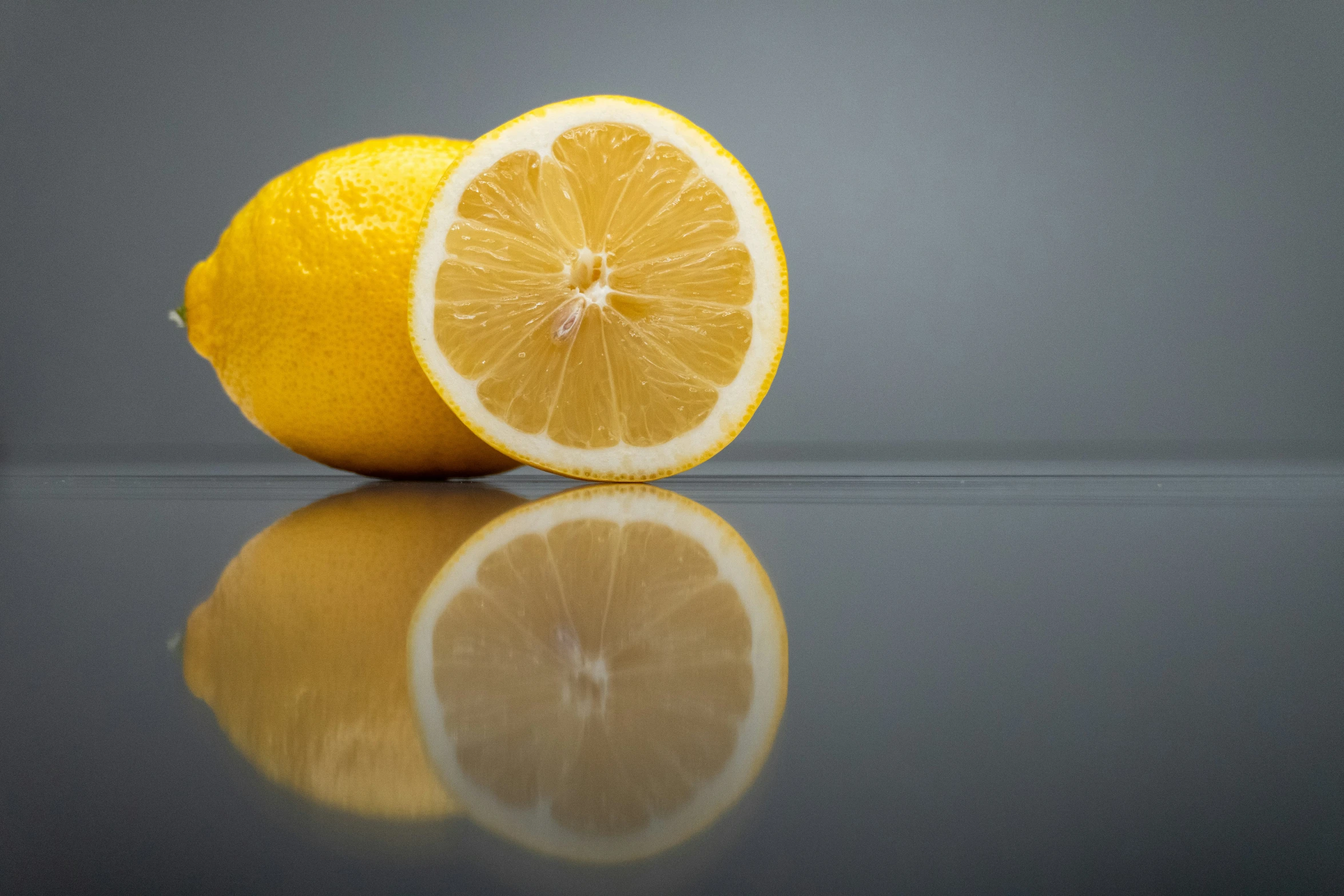 an image of one lemon and the other half sliced