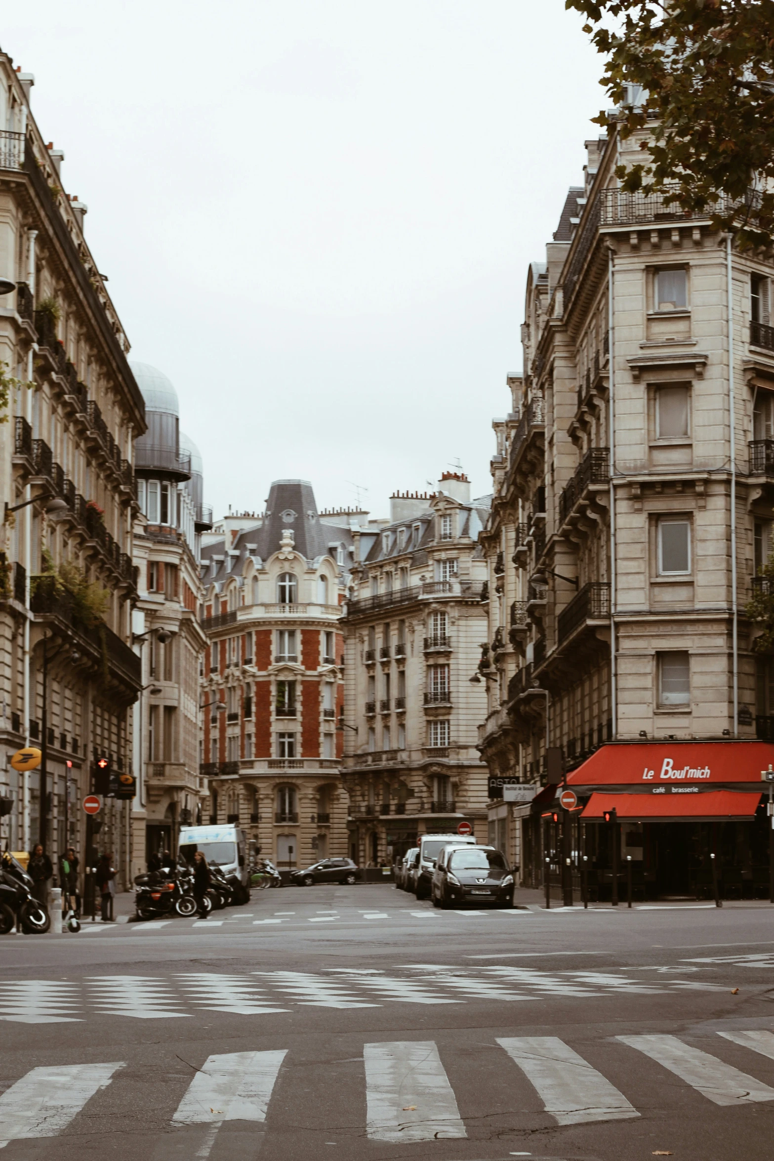 a crosswalk with several large buildings near by