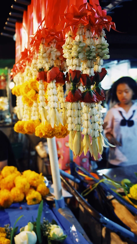 the flowers are all hanging up at the stand