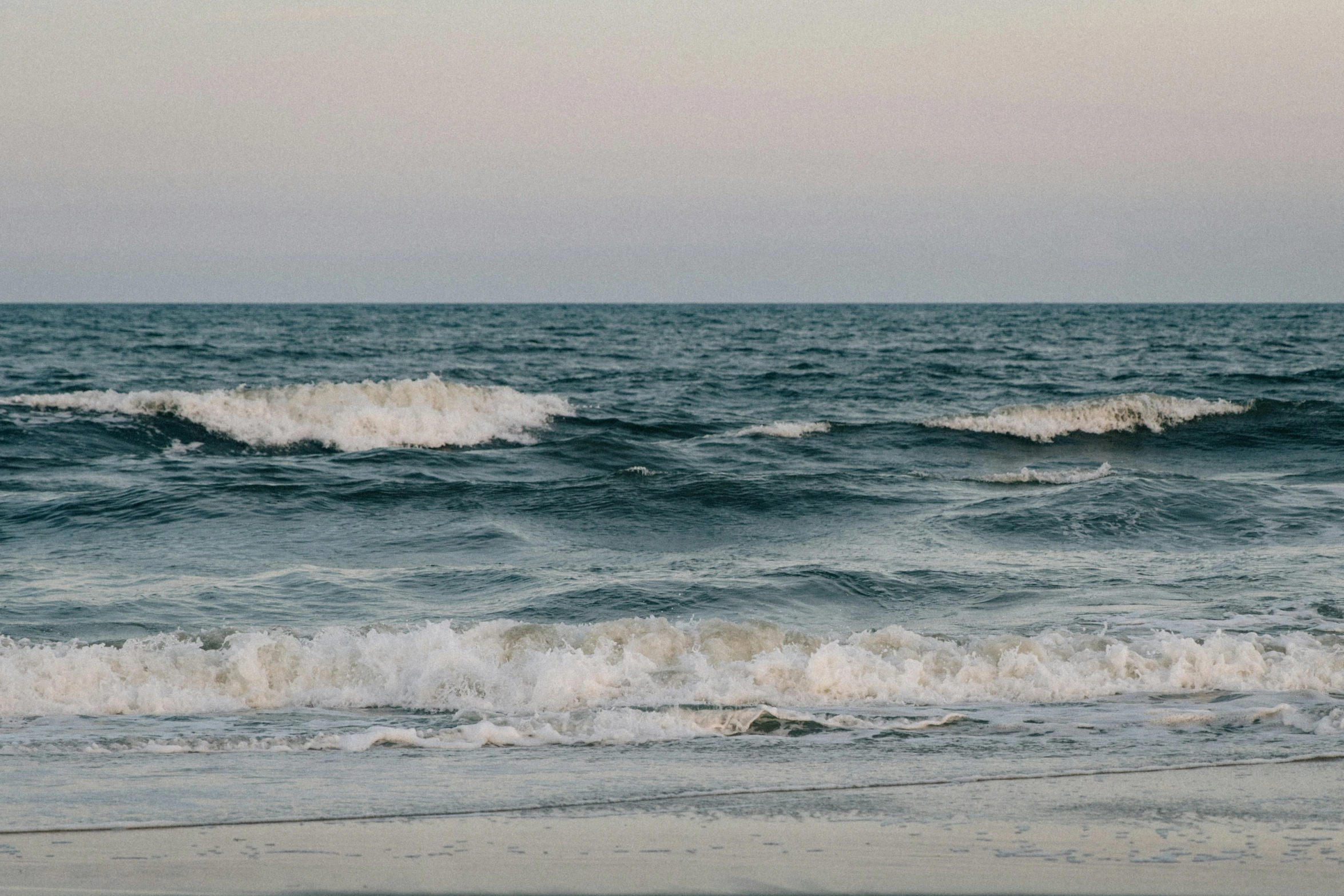 a small boat sails in the calm sea