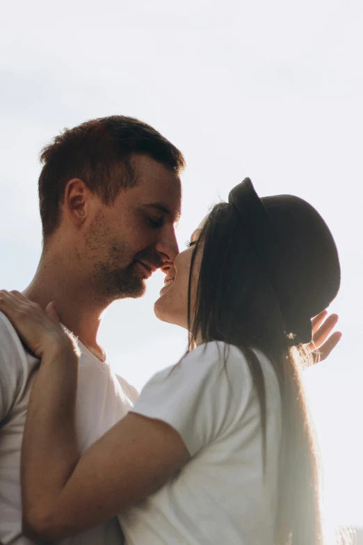 a woman standing next to a man's forehead