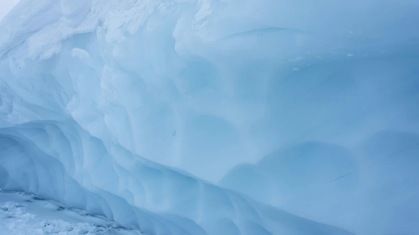 man snow skiing and coming out of an ice cave