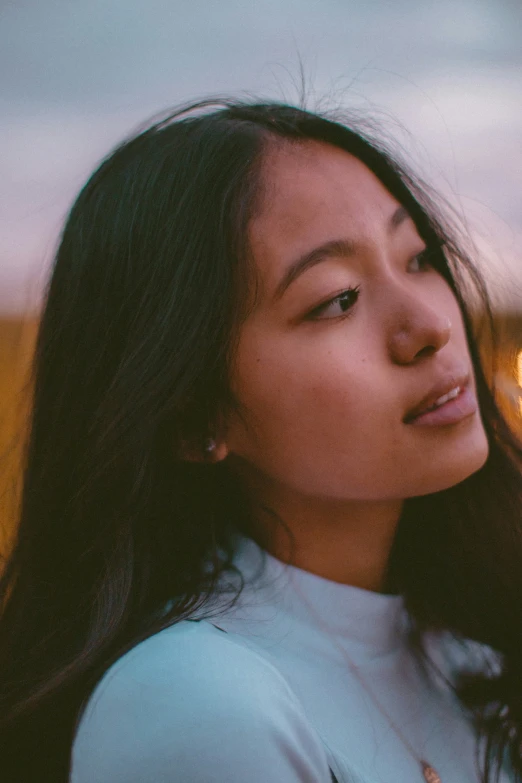 an asian woman with long hair and white dress is outside