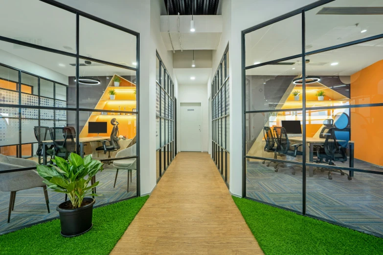 this is an office that has glass walls with a view to the hallway