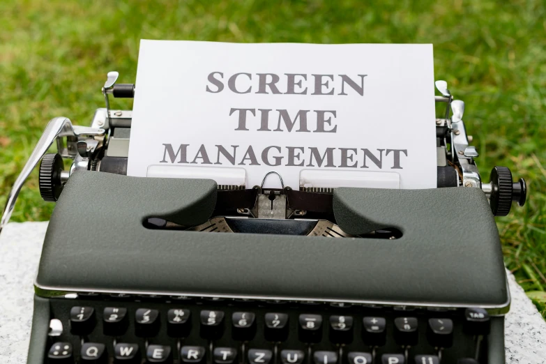 an old typewriter with screen time management printed on it