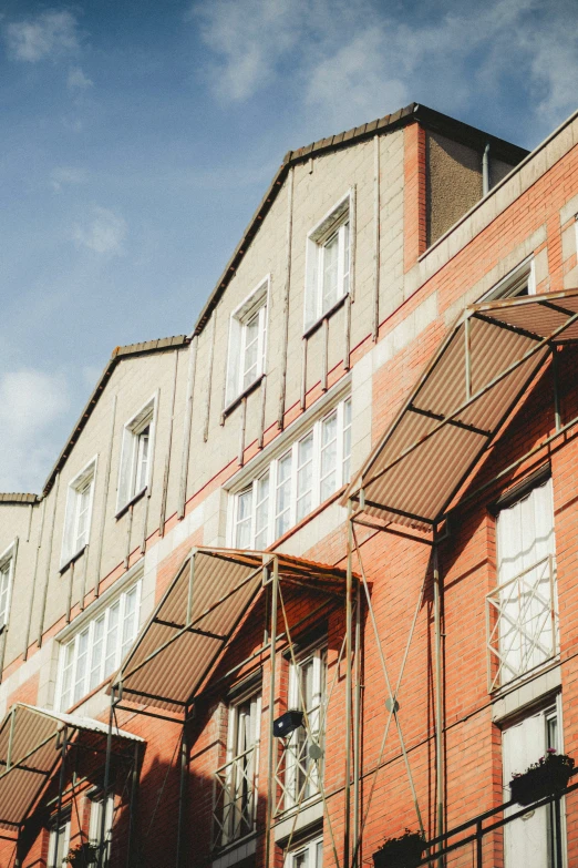 a row of red brick buildings that have closed windows