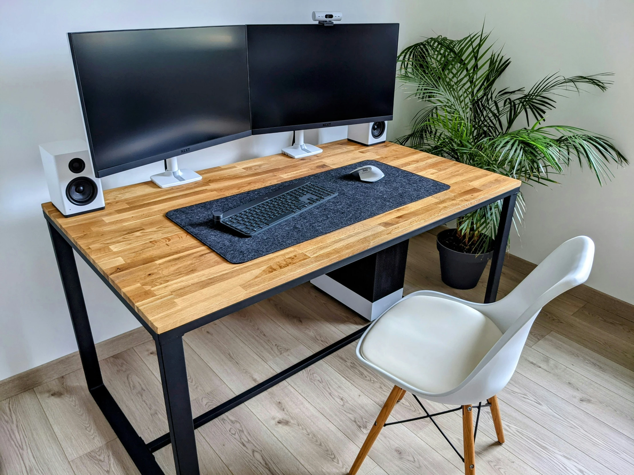 a desk that has two computer monitors on it