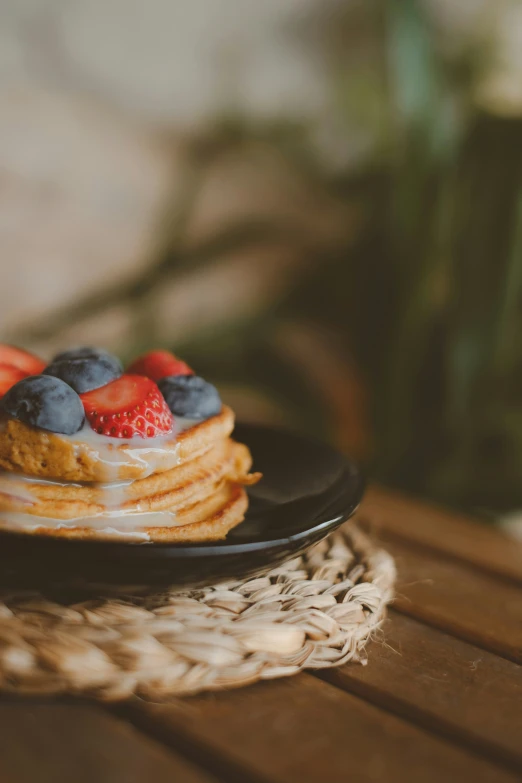 plate of food with berries and a waffle on it