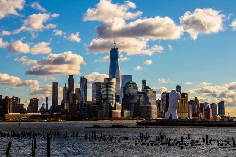 clouds and buildings near the waterfront during sunset