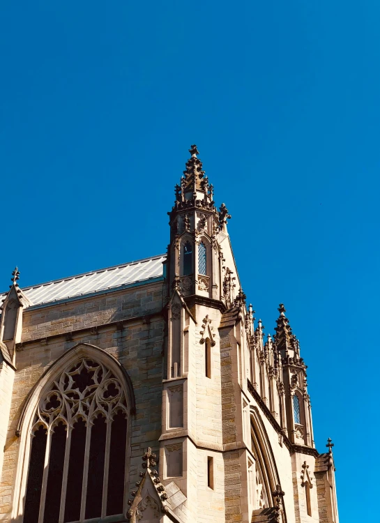 a large church with clock tower against a blue sky