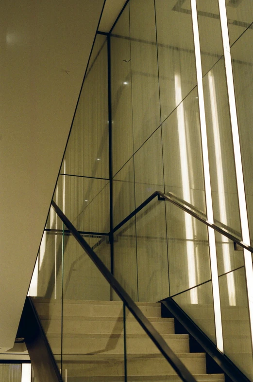 the top of a glass railing with a stair