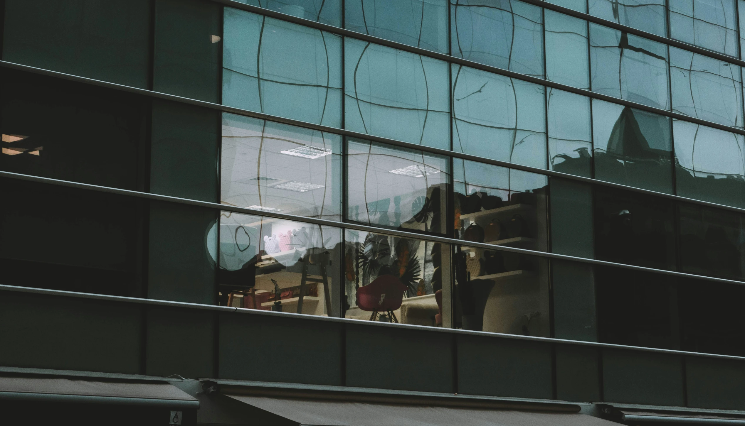 a building is reflected by its shiny glass