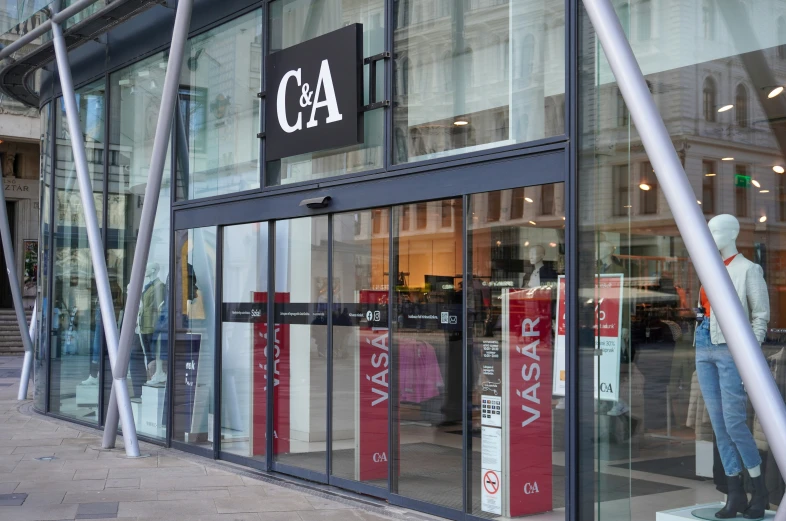 a store window with some tall poles near by