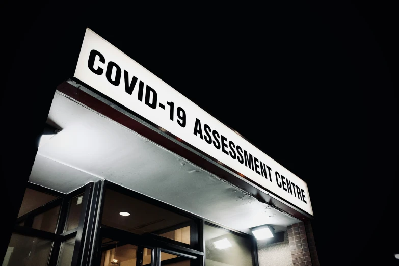 a building at night with a sign on the outside of it