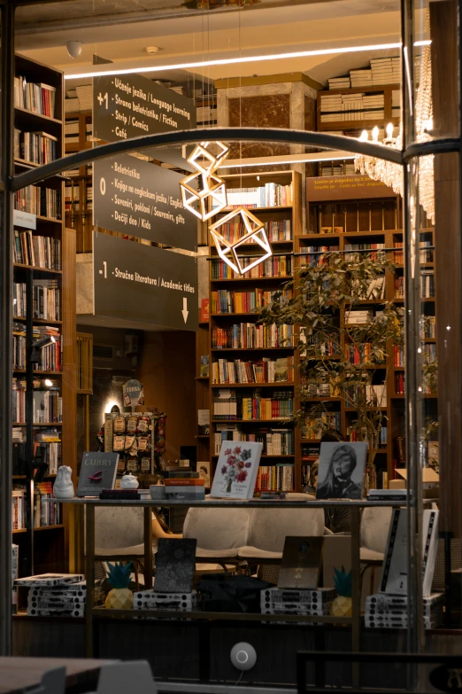 a large liry filled with books and a number of white chairs