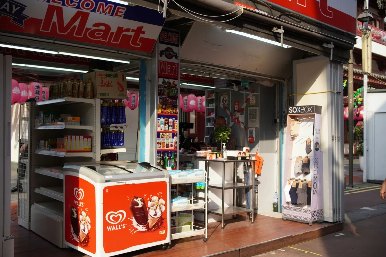 a store front displays a small, but functional refrigerator