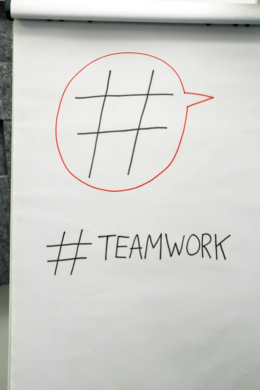 the words team work written in black and red ink