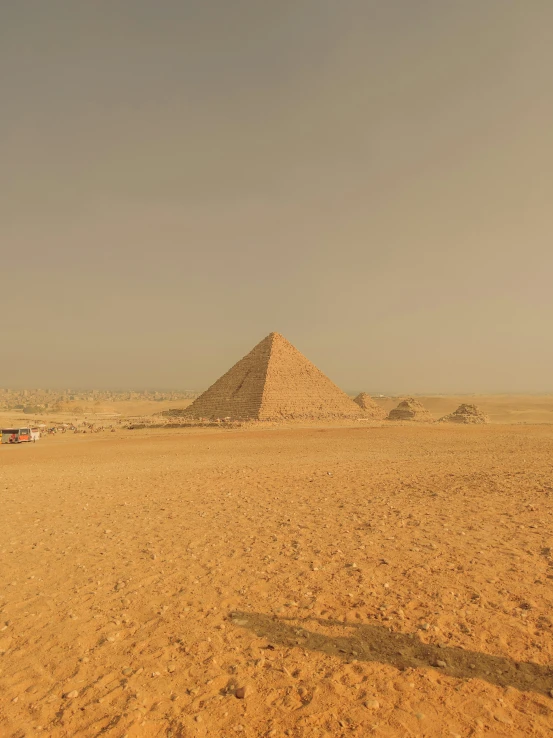 the old man is on a small motorcycle near the pyramid