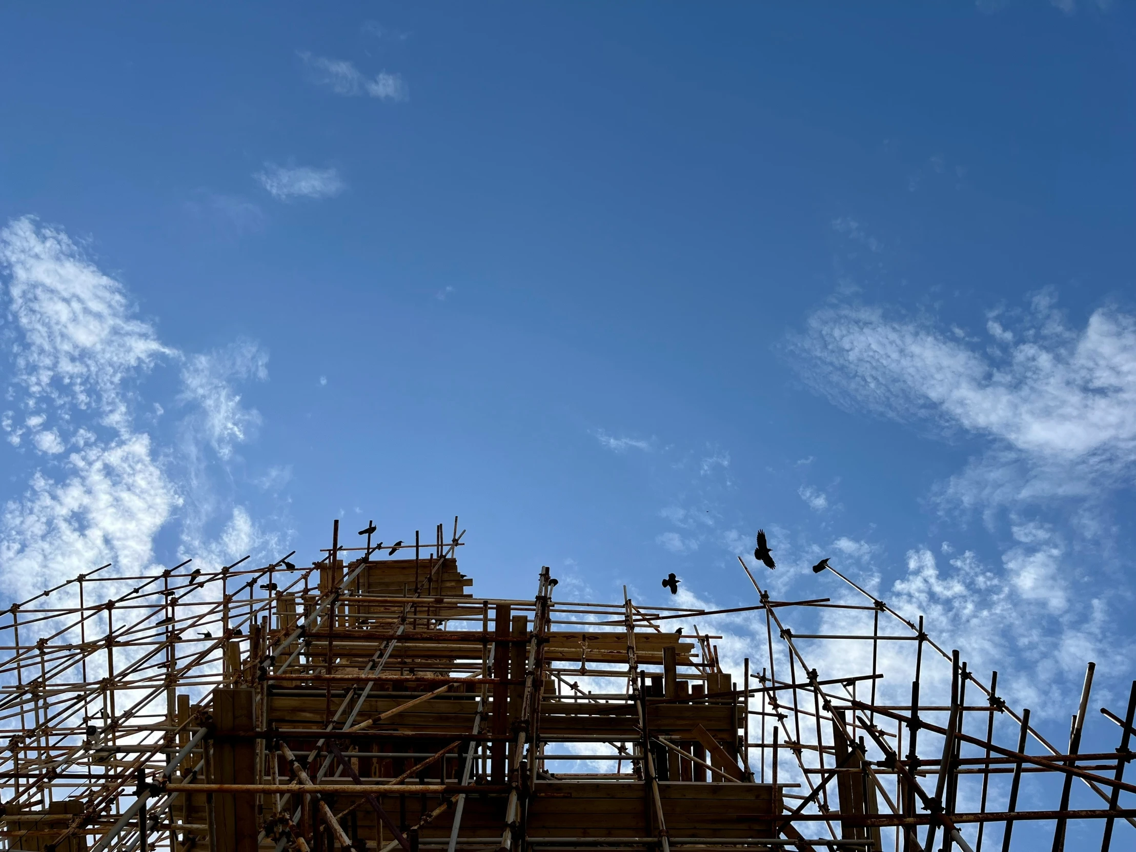 the view of scaffolding with the sky in the background