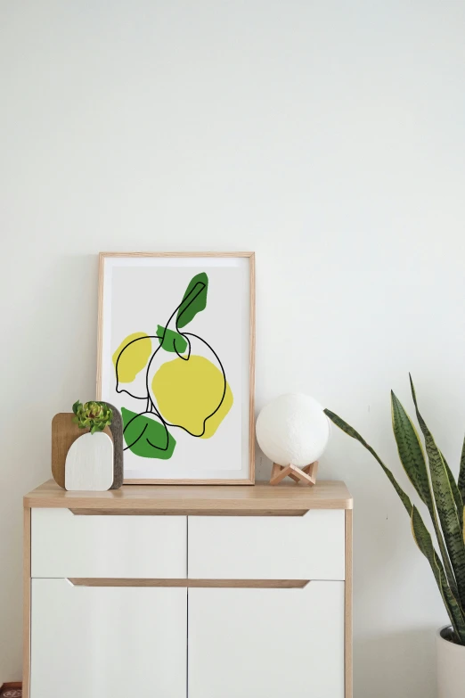 an art print sitting on top of a dresser